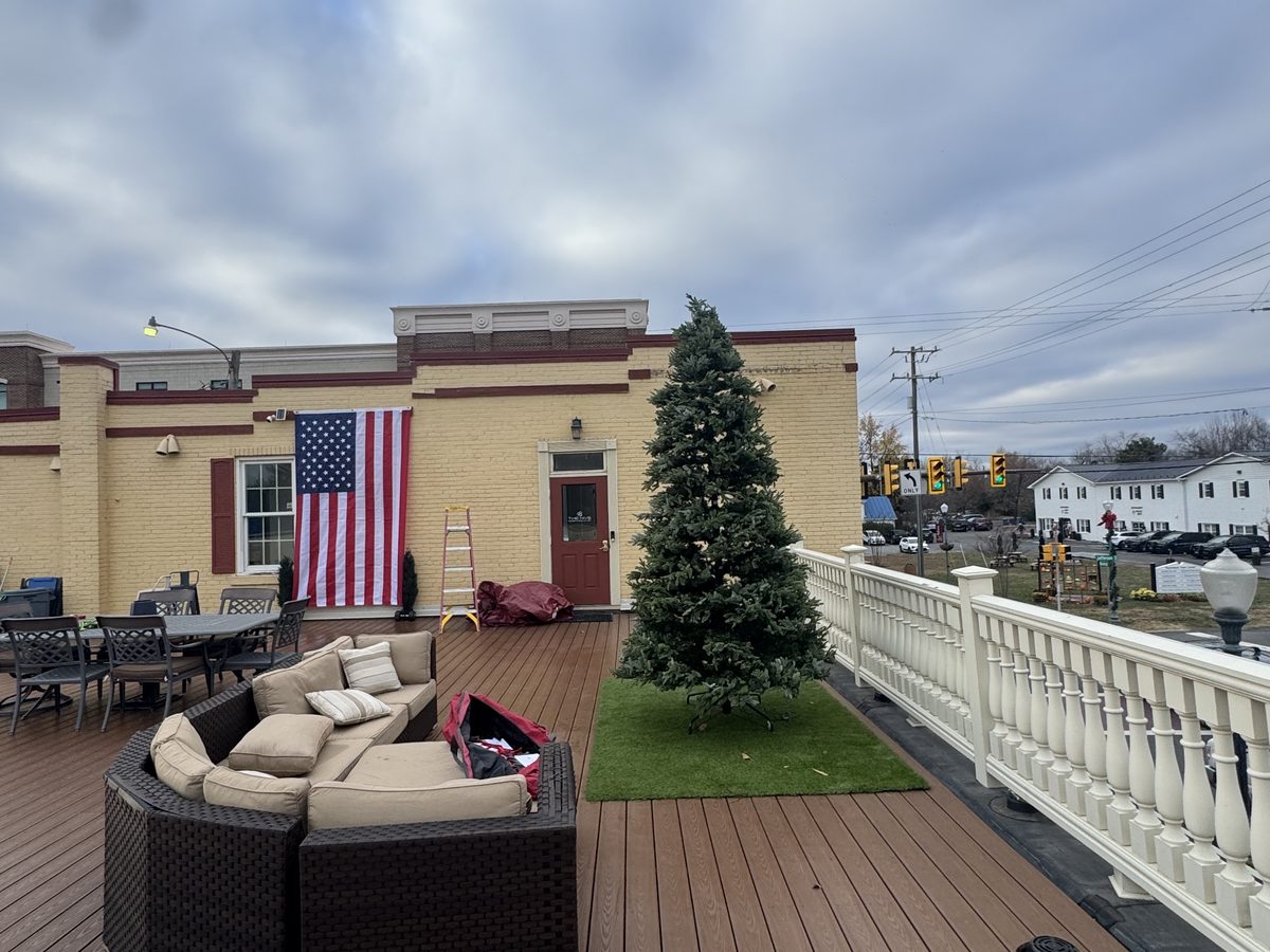 The Hive's rooftop decorated for the holidays with a tree and cozy lounge seating