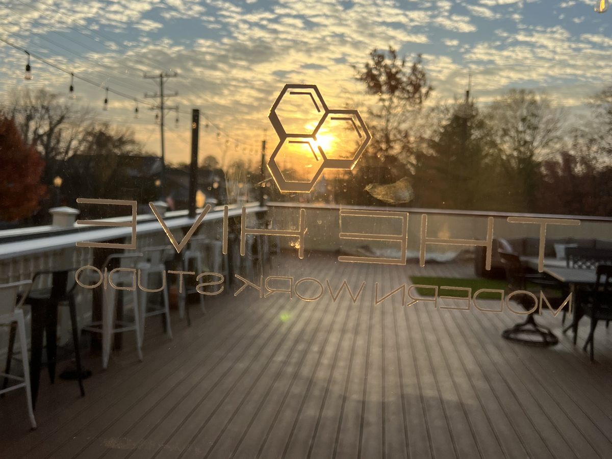 The Hive's rooftop at first light with the hexagon emblem catching the sunrise